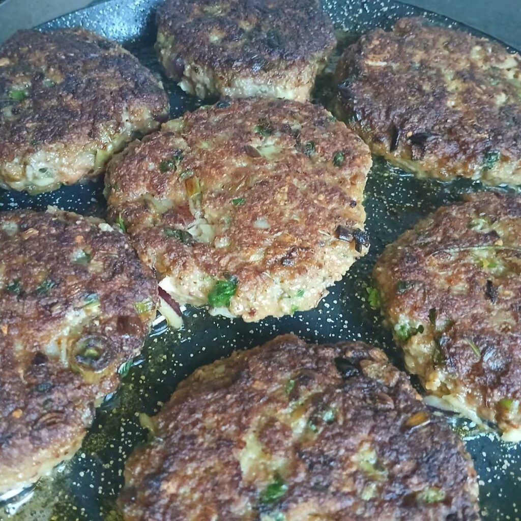 Golden brown Zucchini Carrot Beef Patties pan-fried and ready to serve.