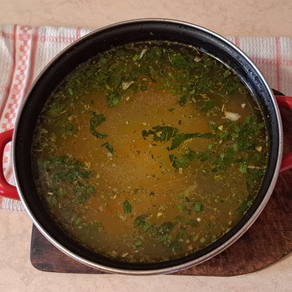 Homemade chicken vegetable soup in pot ready to serve.