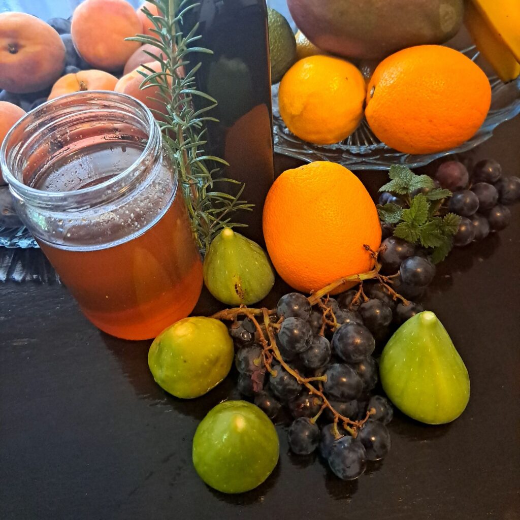 Whole fruits including figs, orange, and grapes prepared for the elegant fruit salad recipe.