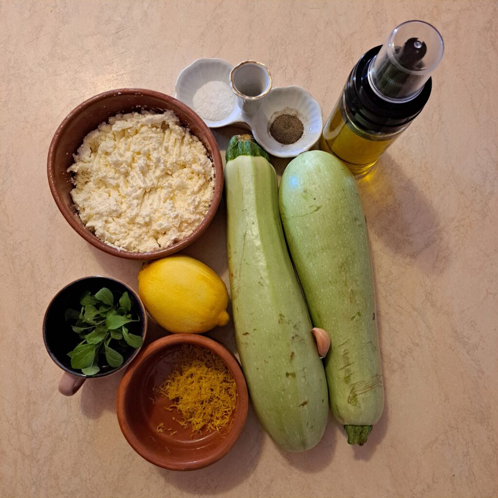 Ingredients on a kitchen table for Grilled Zucchini Rolls with Microgreens.