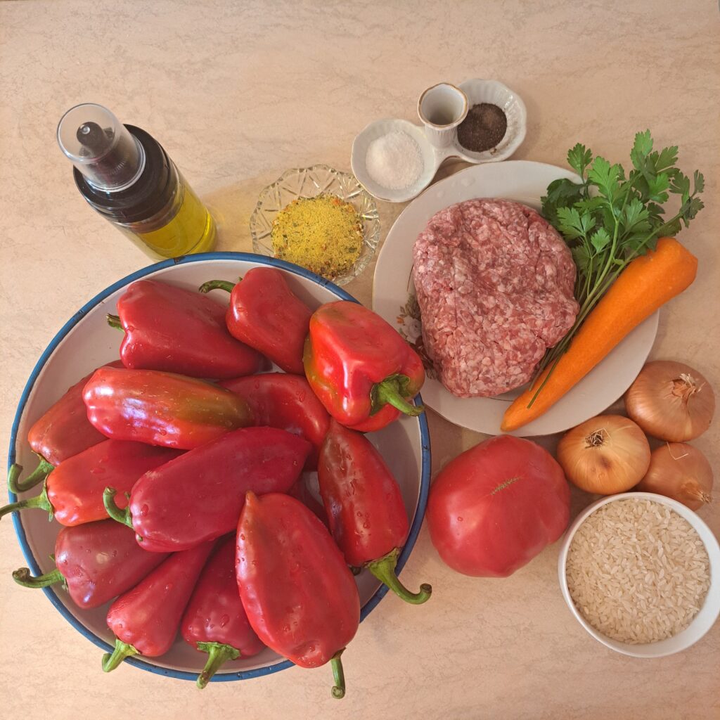 All ingredients for rice pork filled peppers arranged on a kitchen counter. 
