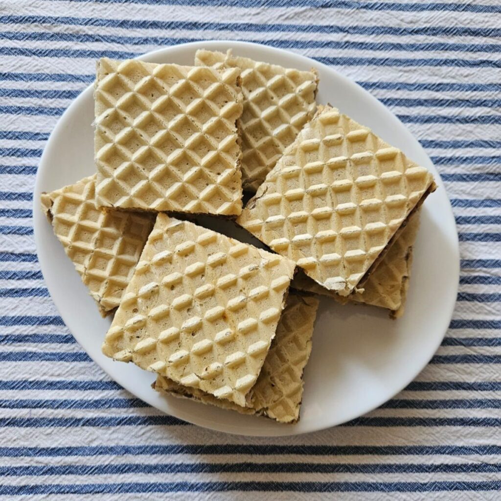 Top view of square Walnut Biscuit Wafer Cakes arranged on a plate for home serving.