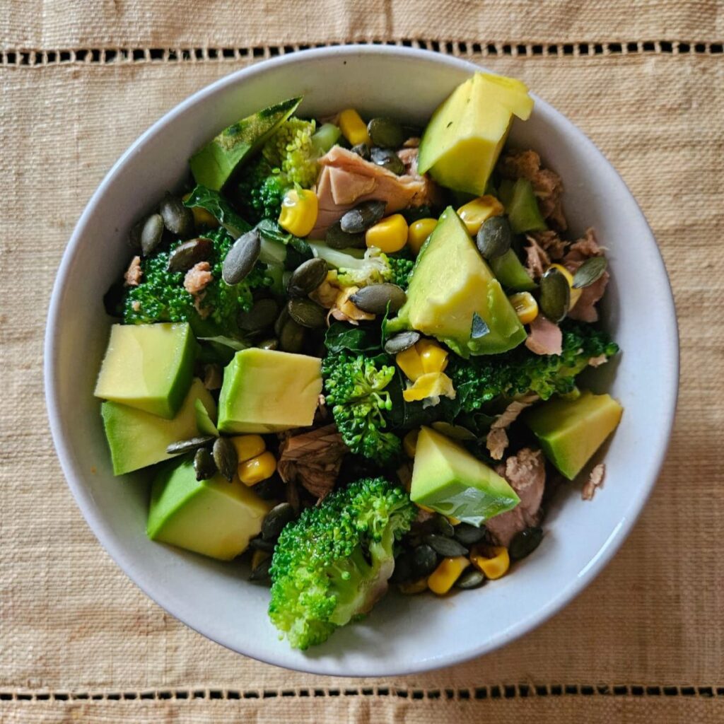 Top view of Avocado Broccoli Tuna Salad served in a small deep bowl.