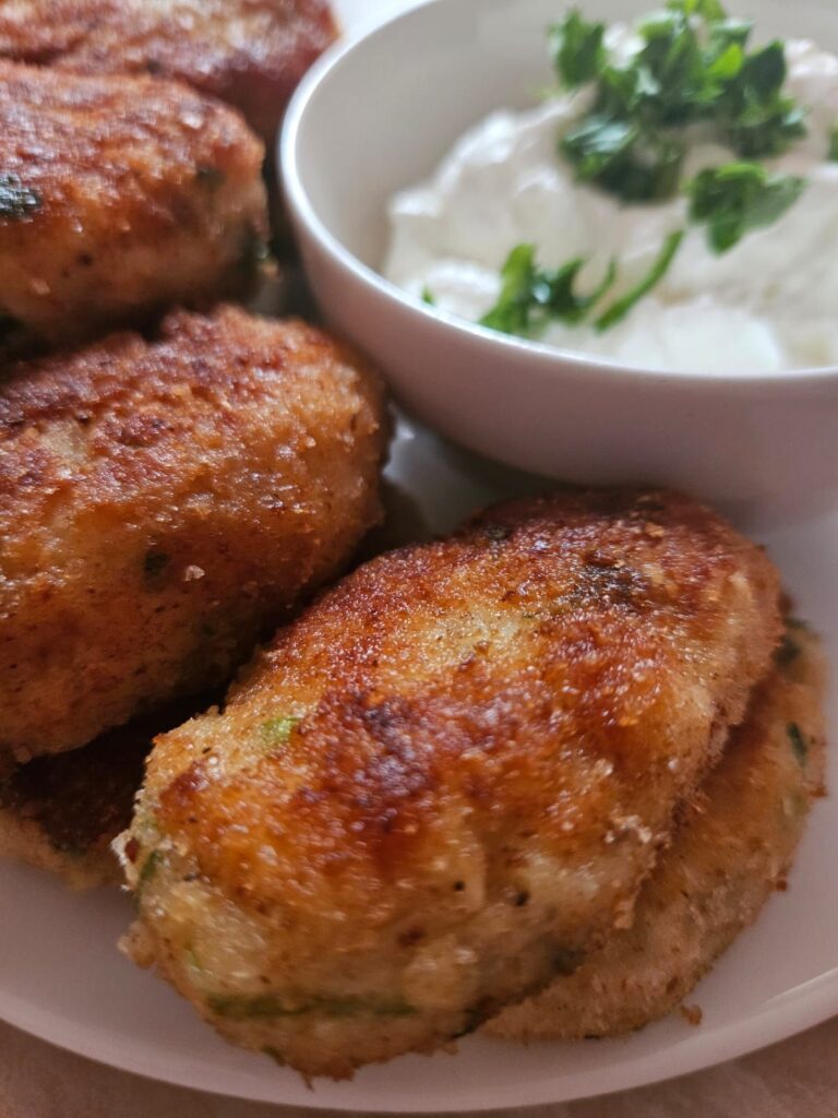 Close-up of served chicken cauliflower bites in a plate with dipping sauce.