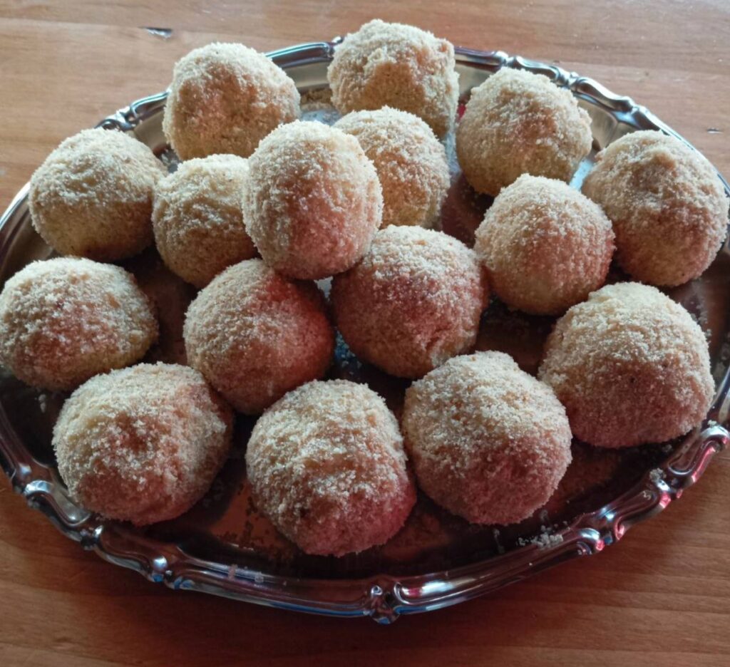 Freshly made potato plum sweet dumplings served in a tray, ready to enjoy.