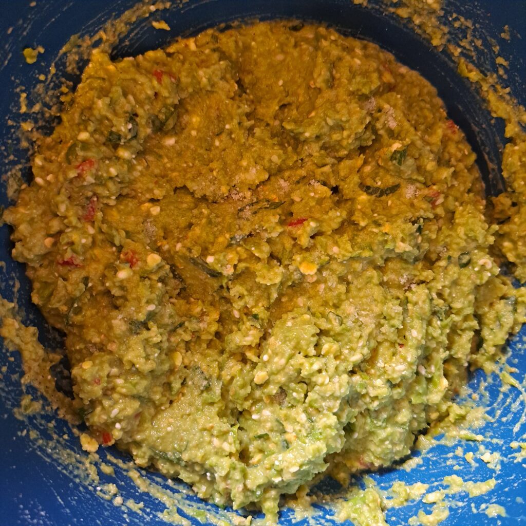 Mixed ingredients for Pea Cheese Bites with Sesame in a deep bowl ready for shaping.