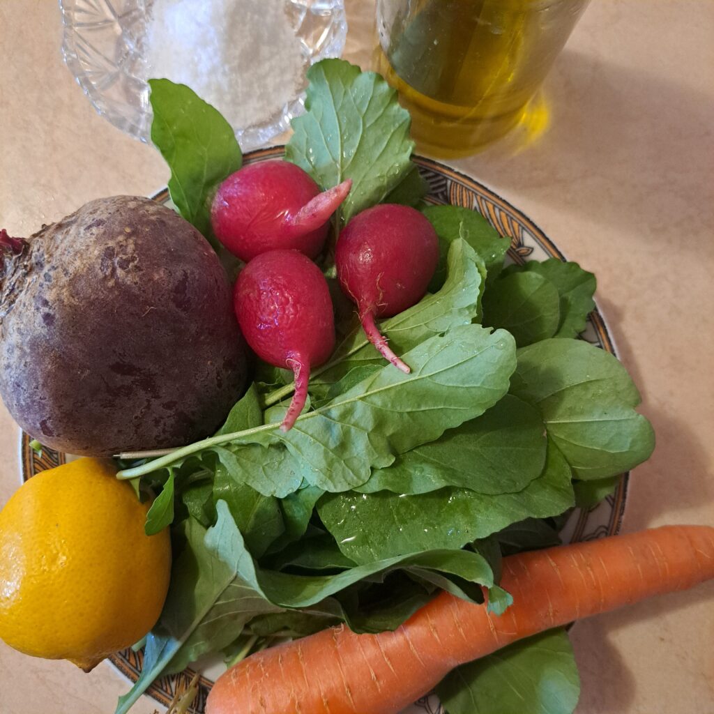 Beetroot, carrot, radish, lettuce leaves, lemon, olive oil, and salt prepared for Carrot Beetroot Radish Salad with Microgreens.