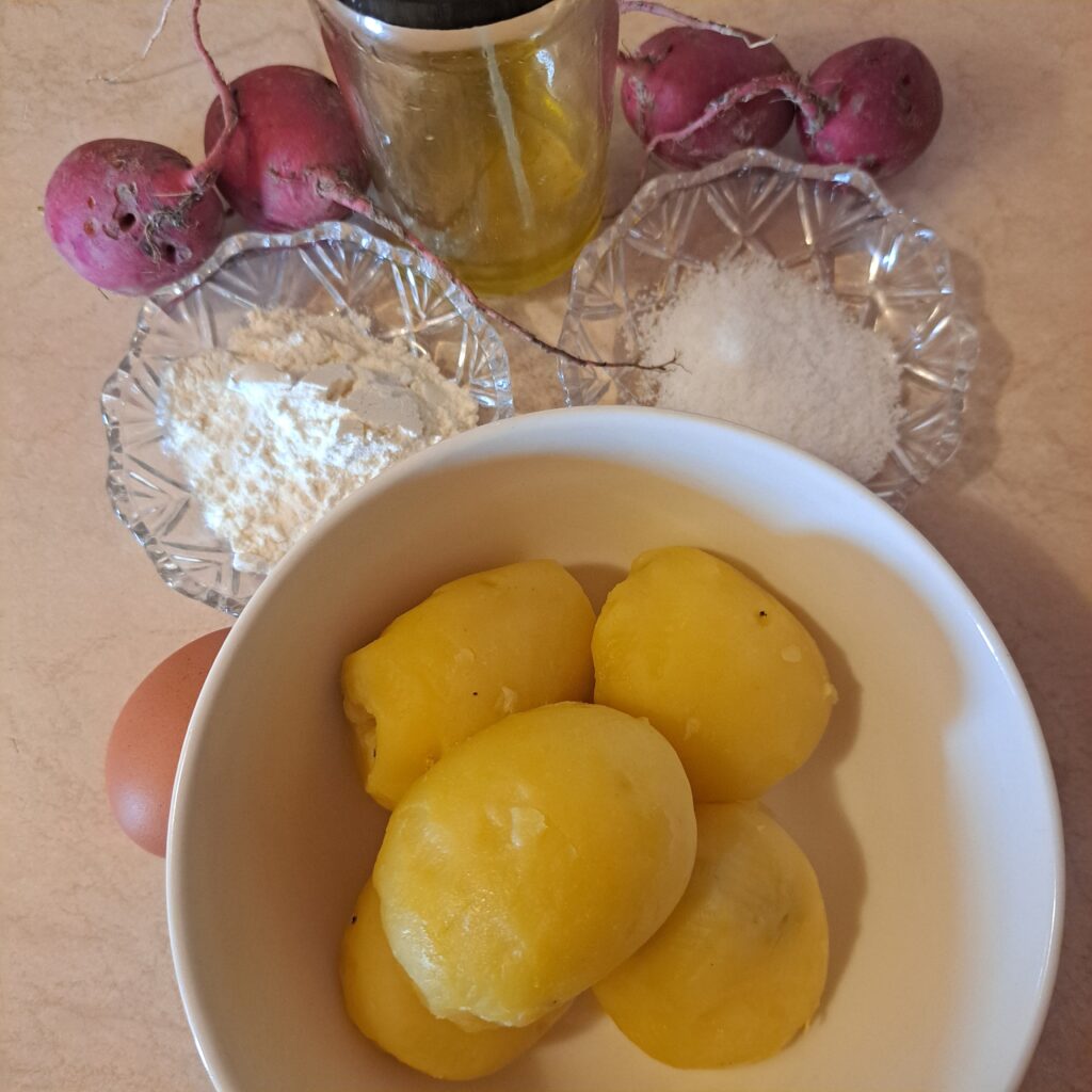 Ingredients for Microgreens Potato Radish Delight: boiled potatoes, fresh radishes, olive oil, flour, egg, and salt neatly arranged and ready for making the dish.