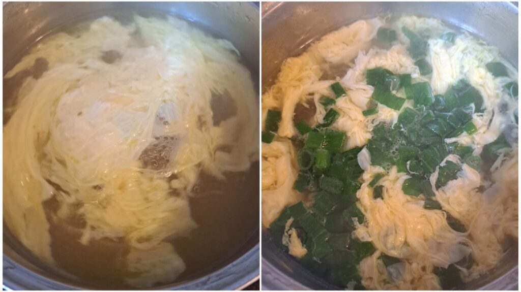 Beaten egg being added to hot water and chopped spring onions added to the soup.