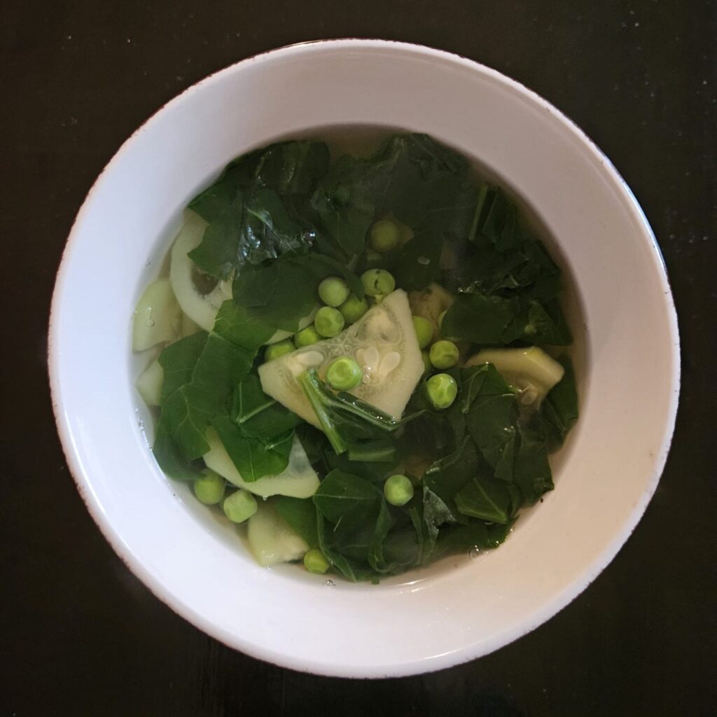 Served spinach, zucchini, and pea soup in a bowl, ready to enjoy.