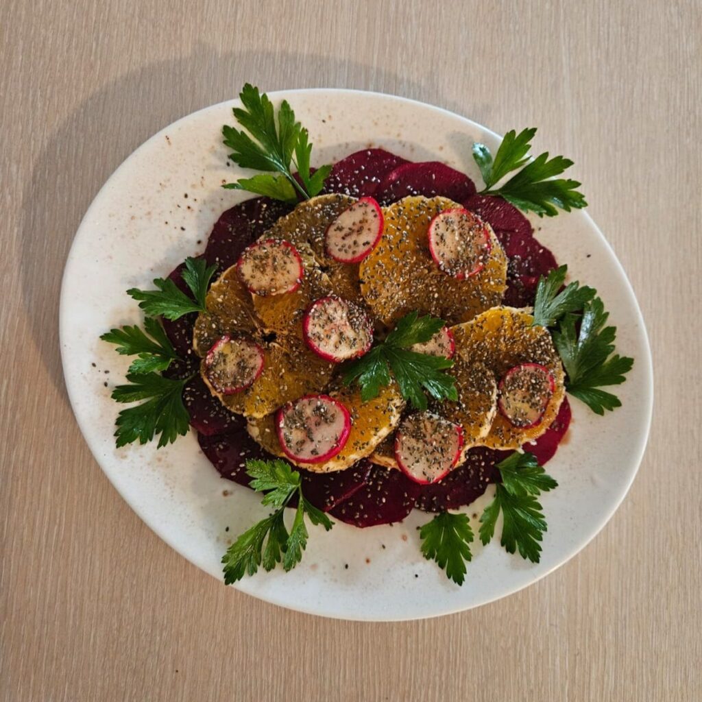 Colorful Beetroot Orange and Chia Seed Salad with radish, parsley, olive oil, balsamic vinegar, salt, and black pepper.