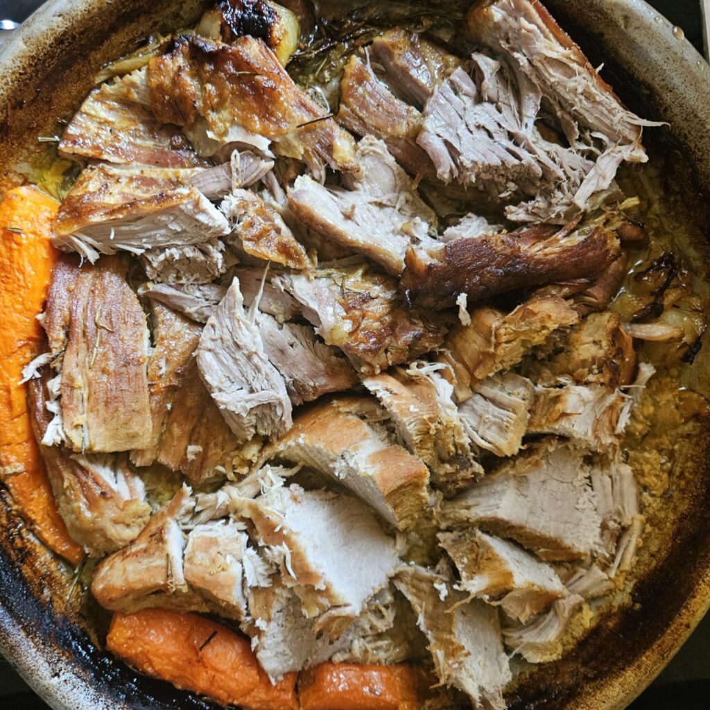 Wood Fired Pork Roast sliced into pieces and served directly in the round baking tray.
