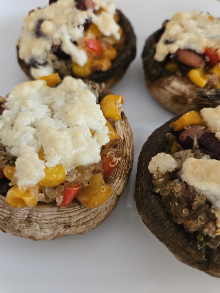 Close-up of Quinoa Stuffed Mushrooms with Cheese freshly served on a plate.