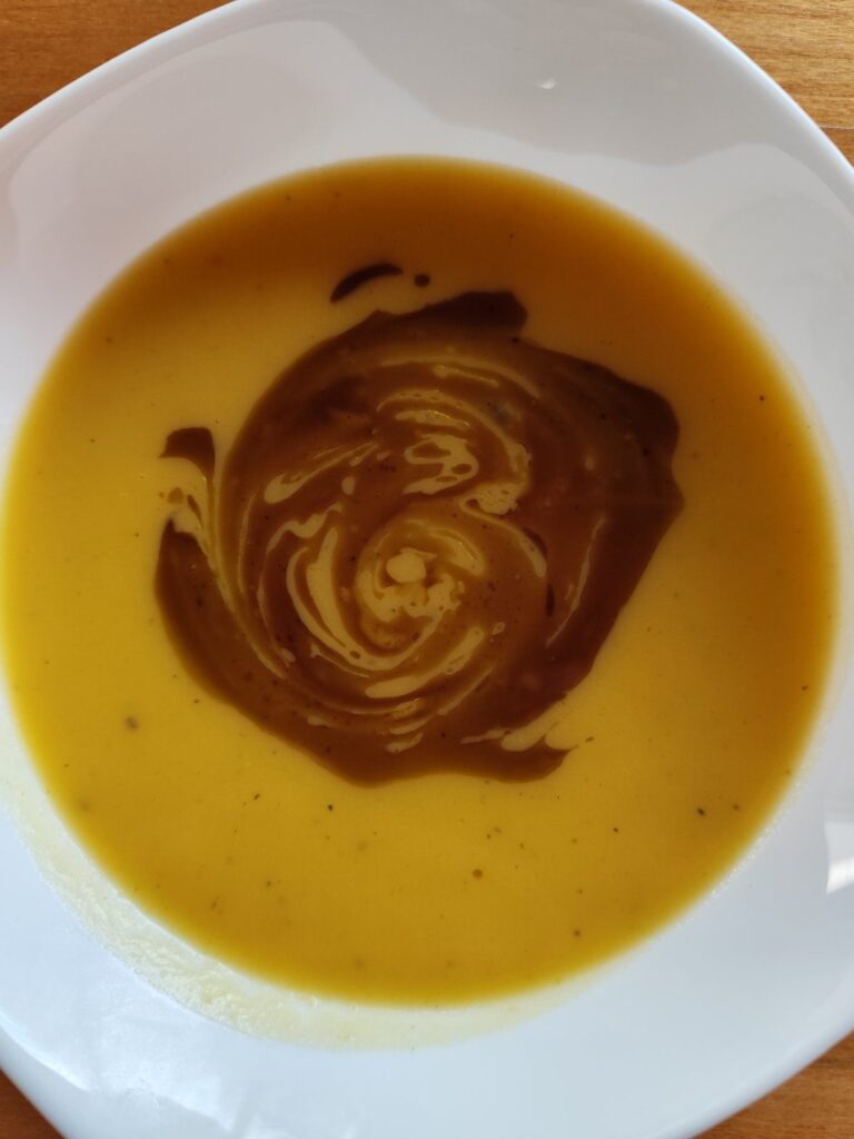 Creamy Golden Butternut Squash Soup served in a bowl, close-up view showing smooth texture.