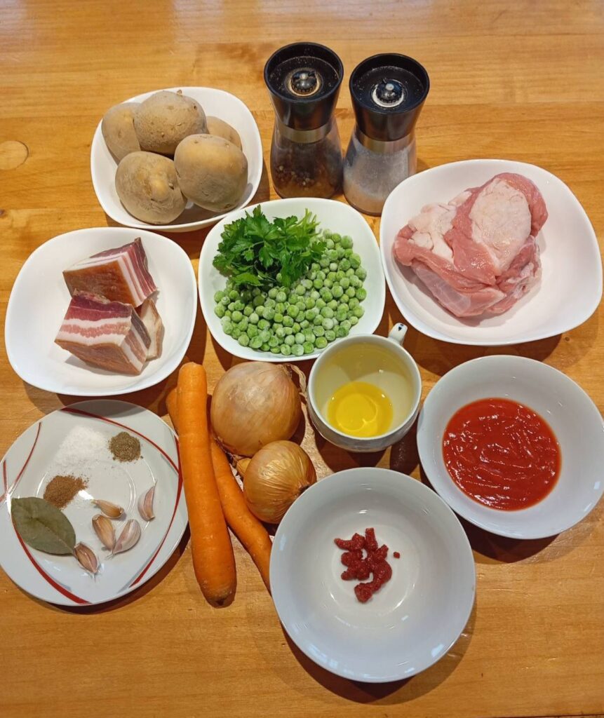 All ingredients for Beef Pea Potato Stew neatly arranged on a kitchen table, ready for preparation.