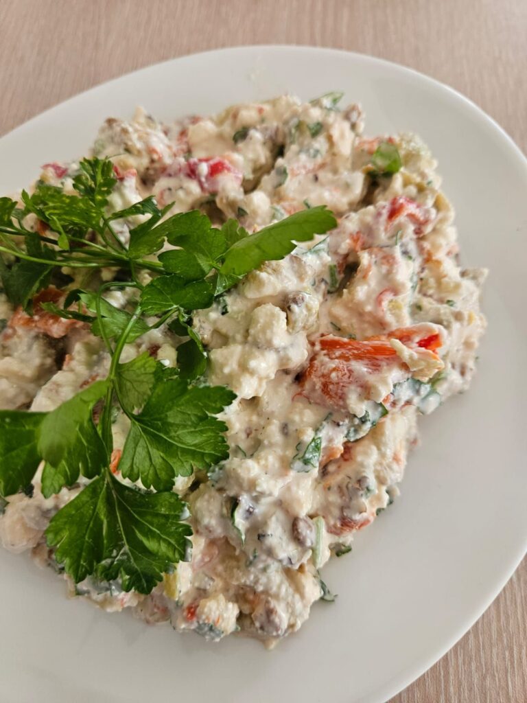 White plate with Roasted Peppers Walnut Salad.