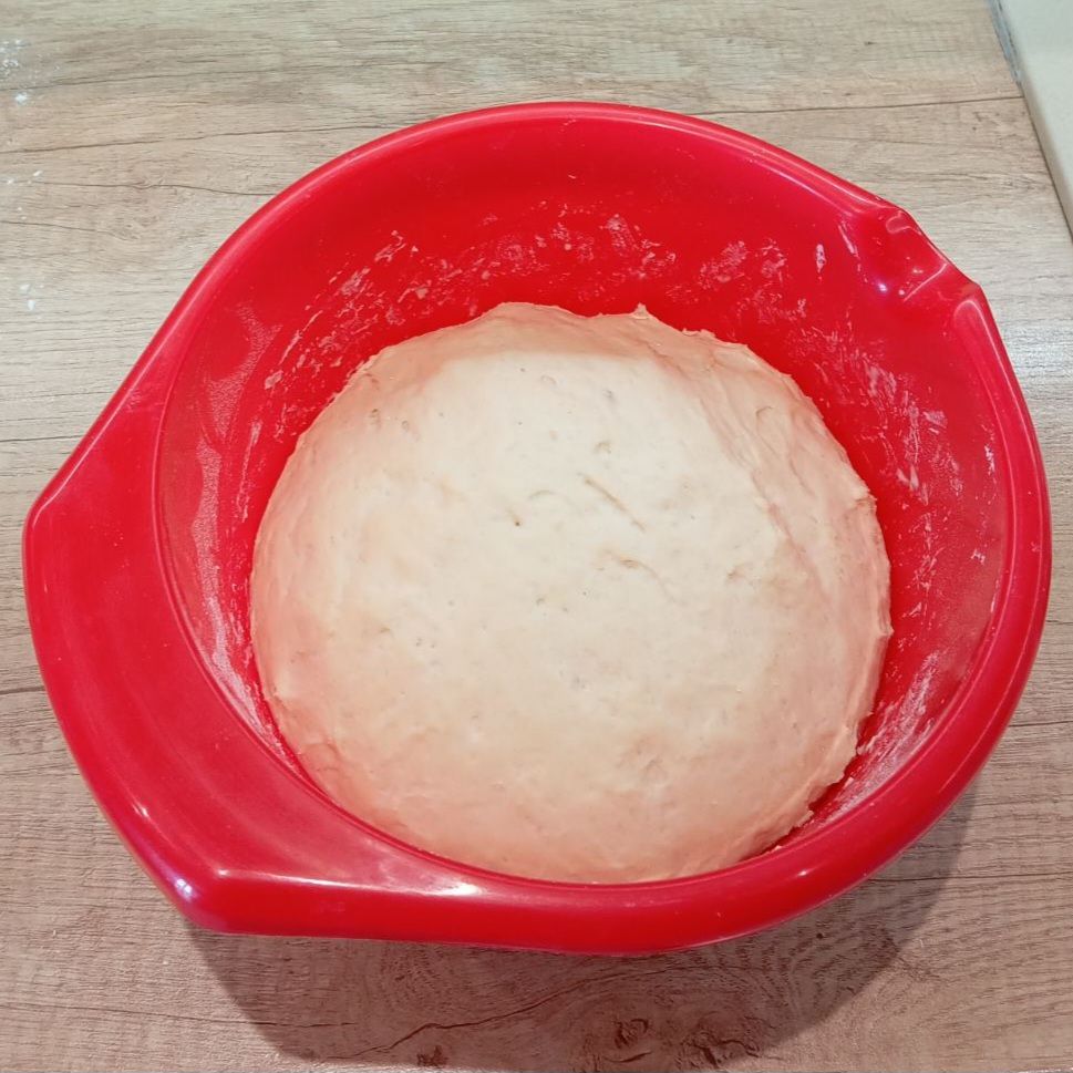 Mixing soft flour, dry yeast, milk, and salt in a bowl to prepare dough for Fried Folded Ham Pizzas.