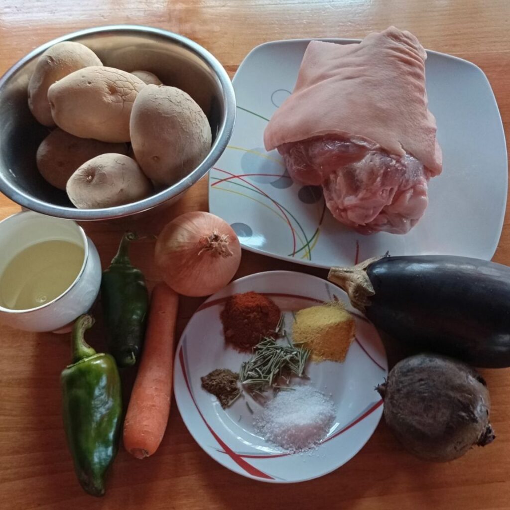 Prepared ingredients for Roasted Pork Veggie Plate arranged on a kitchen table before cooking.