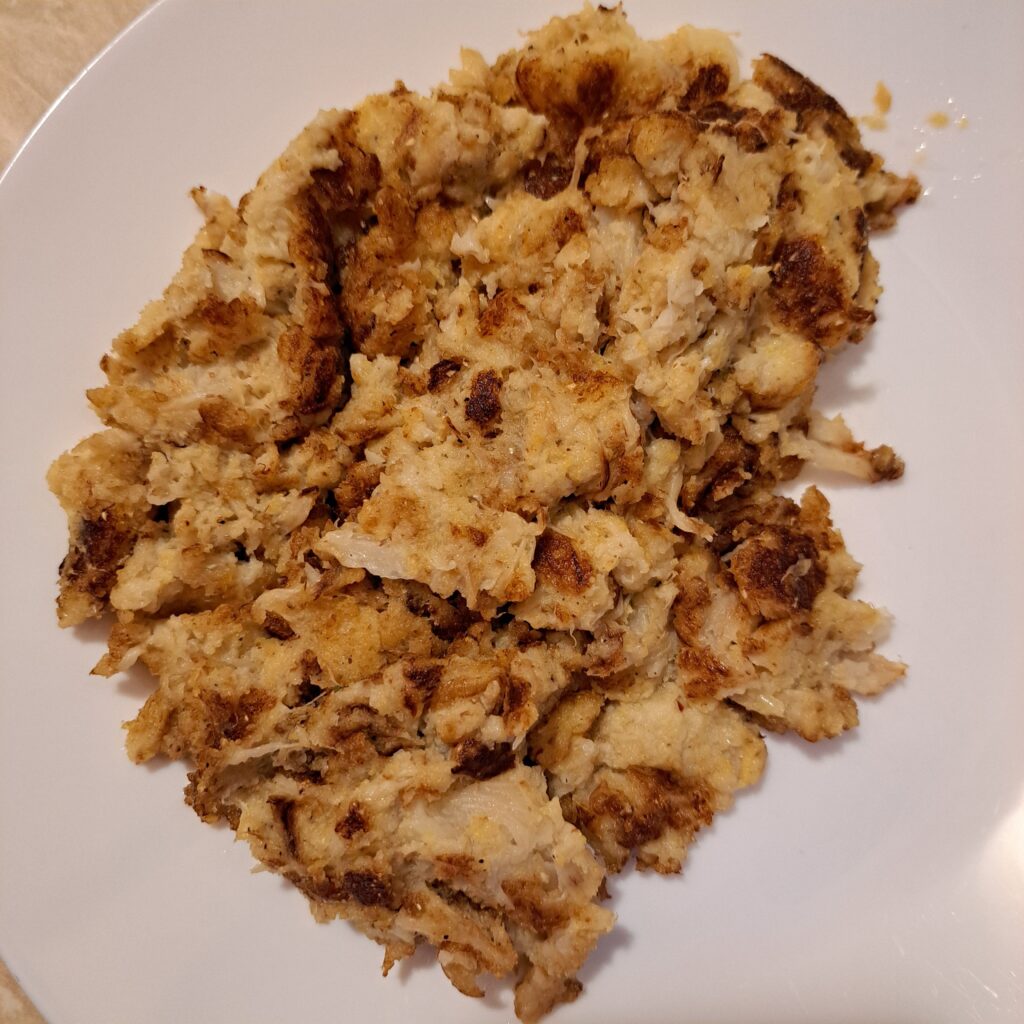 Boiled cauliflower lightly fried with corn flour and placed on a plate. 