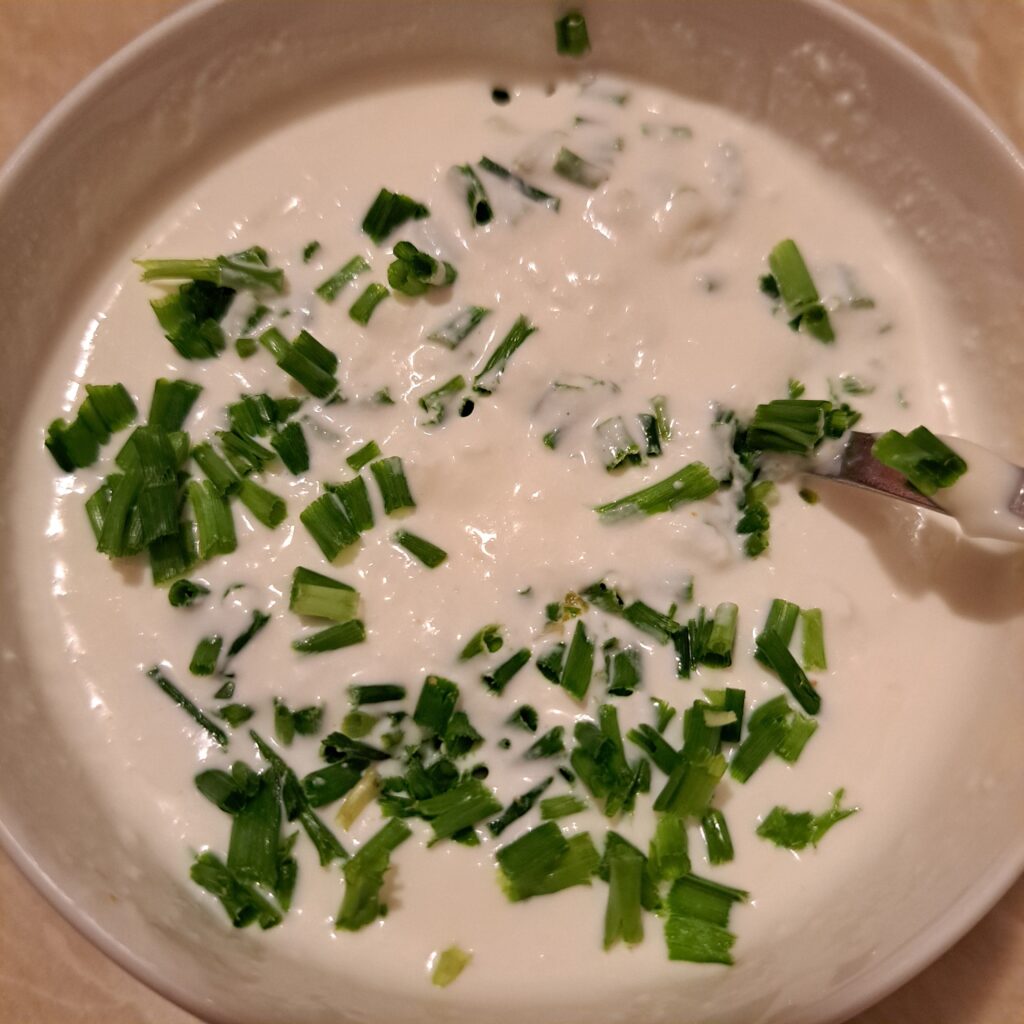 Sour cream and mayonnaise sauce with garlic and chives prepared for the Crispy Pork Veggie Plate.