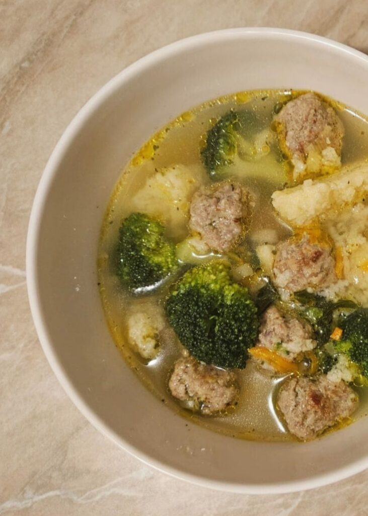 Close-up of Beef Meatball Dumpling Soup served in a bowl with dumplings, small beef meatballs, and mixed vegetables.