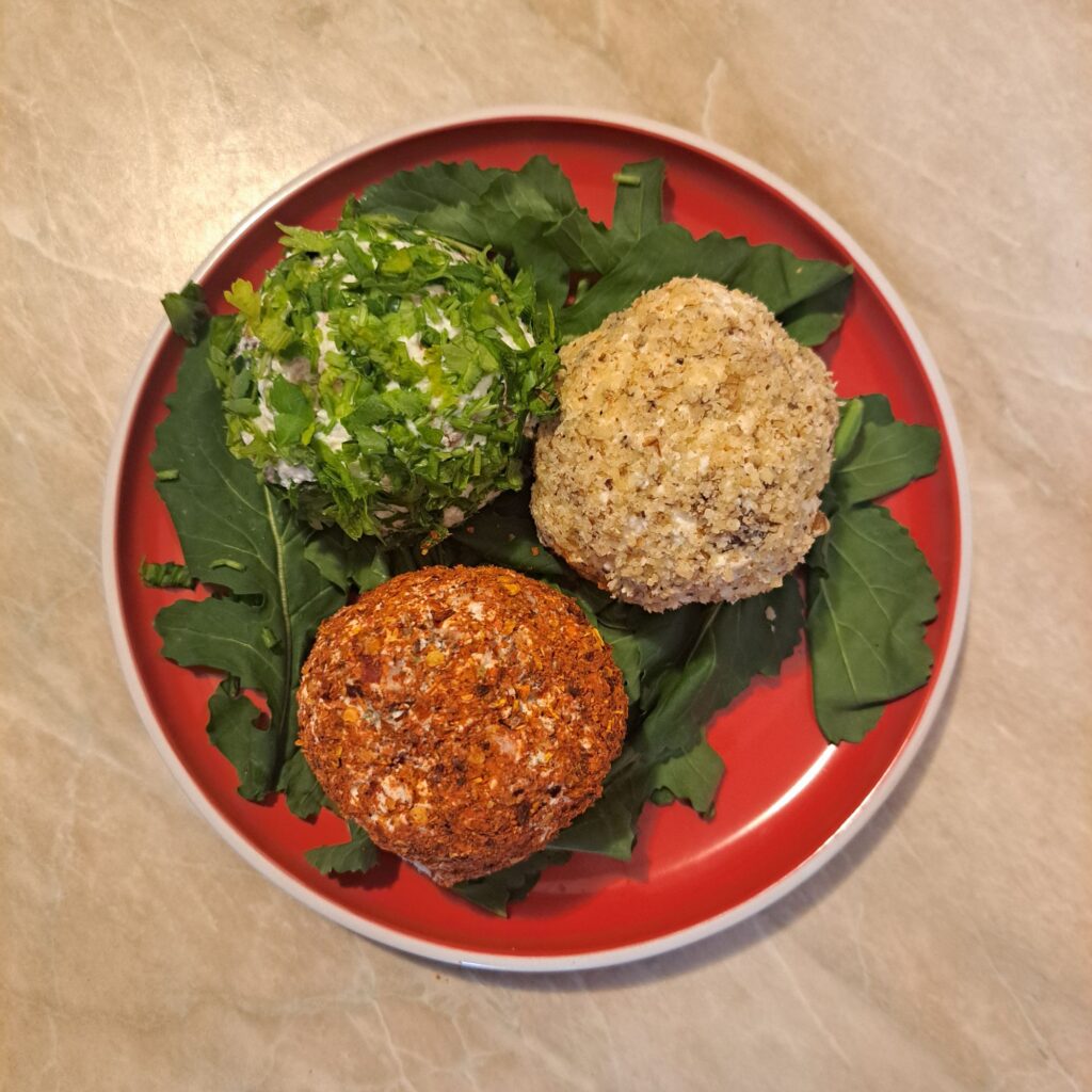 Cheese Meat Sunflower Balls served on a flat plate with fresh arugula as a base, showing three coated balls ready to enjoy.