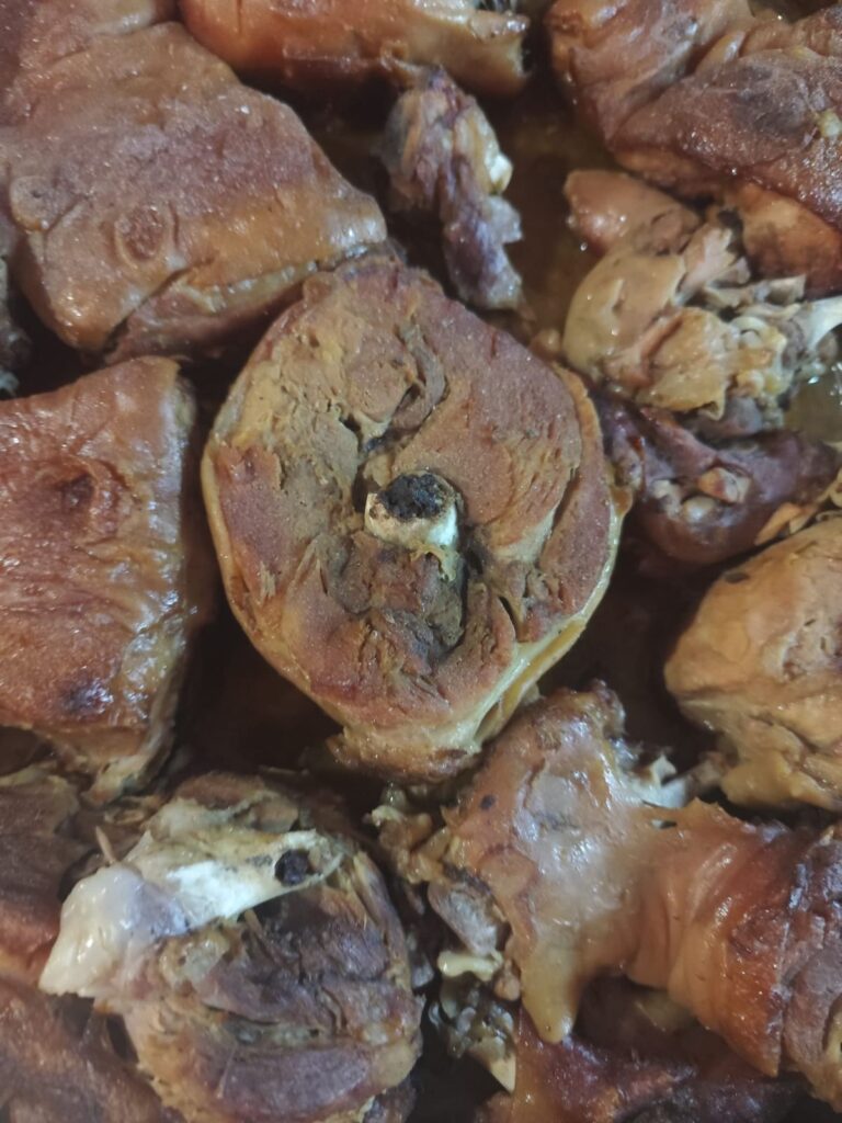 Roasted meat shown close up with golden surface and tender texture.