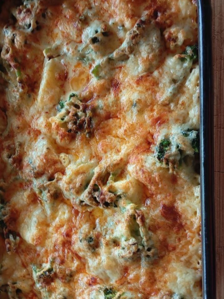 Top view of whole Vegetable Egg Cheese Moussaka in the baking pan with melted cheese and vegetables.