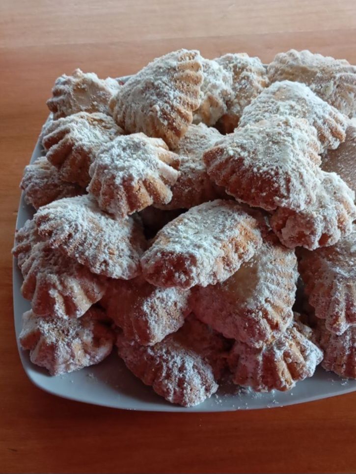 Large plate filled with freshly baked soft walnut sugar cookies, arranged neatly and ready to serve.