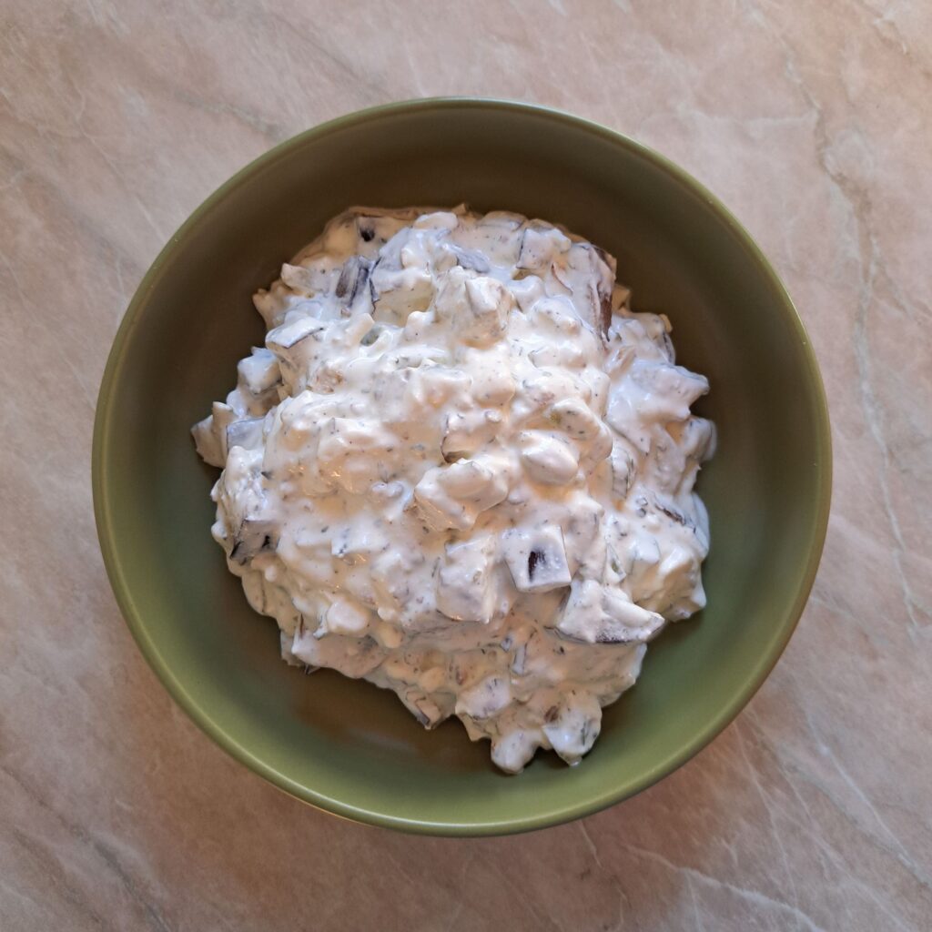 Creamy Eggplant Walnut Salad served in green bowl with smooth and evenly mixed texture.