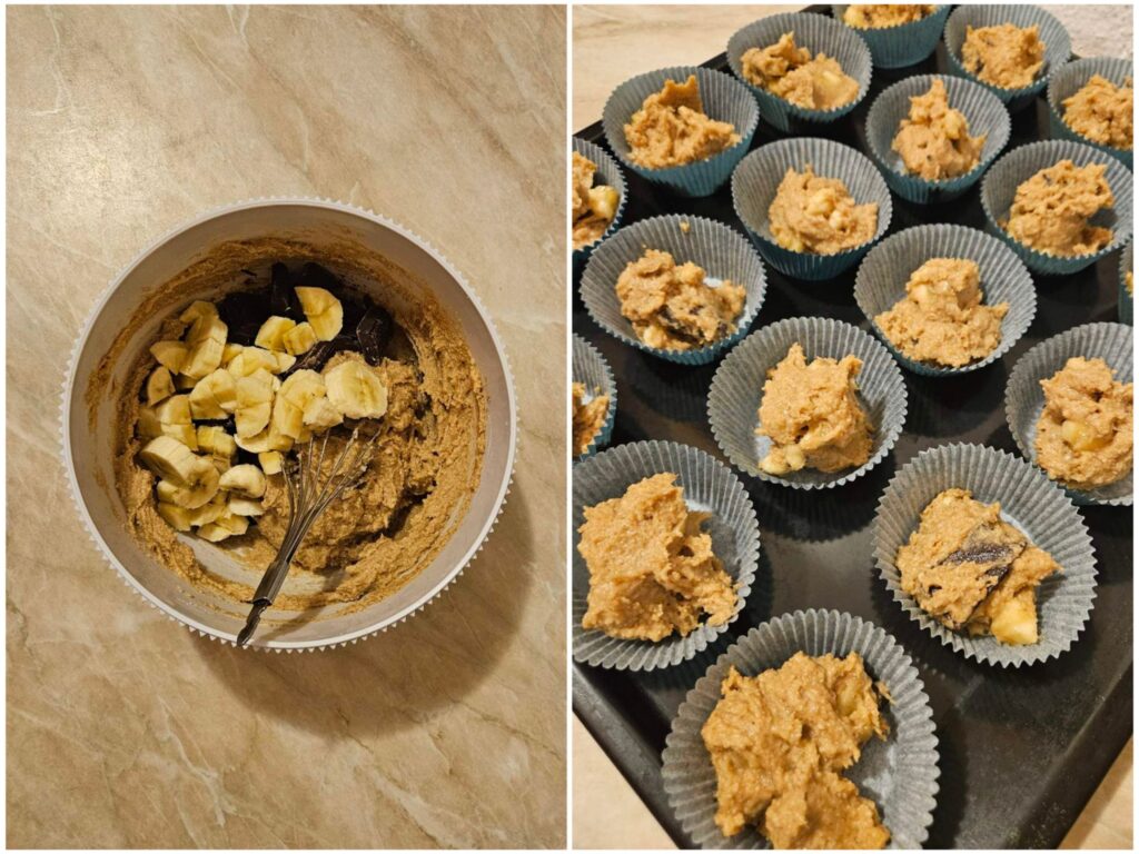 Deep bowl with smooth chocolate banana batter next to paper cups filled on a baking tray, ready for the oven.